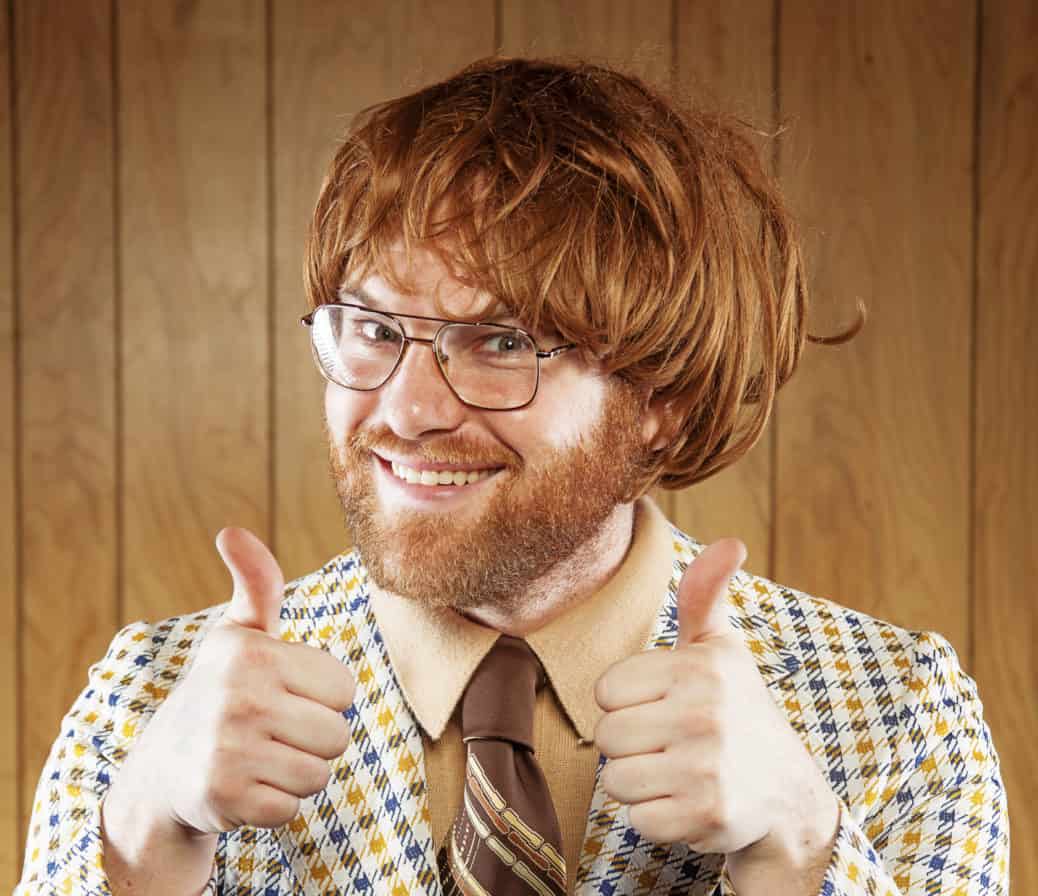 Happy Nerdy 60s Game Show Host Giving 2 Thumbs Up